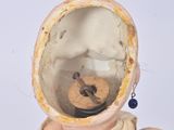 a small teddy bear wearing a space suit on a white surface