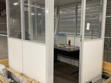 a small room with a glass door and a table in it
