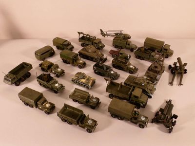 a lot of military vehicles that are on a white surface
