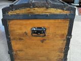 a wooden chest with a metal latch on it