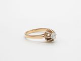 a close up of a diamond ring on a white surface