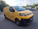 the yellow van is parked in the parking lot near other cars