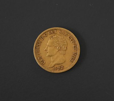 a close up of a gold coin on a black surface