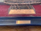 a model of a ship in a glass case on a table
