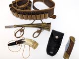 a knife, knife holder, and other items on a white surface