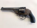 a close up of a revolver on a white surface
