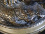 a bronze statue of a person holding a dog