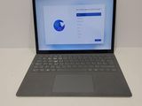 the laptop is sitting on the table with the screen open
