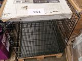 a dog in a cage sitting on top of a pile of boxes