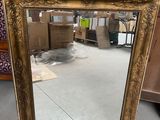 a mirror that is sitting on the floor in the room