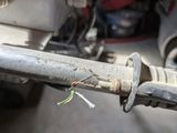 a close up of a metal pipe with wires attached to it