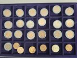 a purple box filled with gold and silver coins