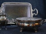 a silver tray with a silver teapot and a silver tray with a silver teapot