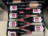 several bottles of wine are lined up in a wine cooler