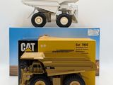 a yellow dump truck and a yellow dump truck in front of a box