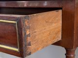 a wooden desk with a drawer on top of it