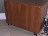 a small wooden cabinet with a laptop on it