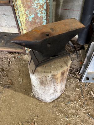 a small piece of metal that is sitting on top of a stump