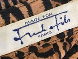 a close up of a label on a leopard print jacket