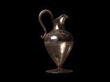 un vase en argent muni d'une anse, sur fond noir