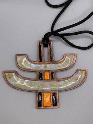 an image of a necklace with a design on it on a white surface