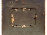 a picture of an old picture frame with a hole in it
