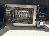 a microwave that is sitting on a counter with its door open