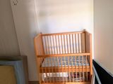 a crib in the corner of a room with a crib next to it