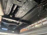 the underside of a car with a broken exhaust pipe and exhaust pipe