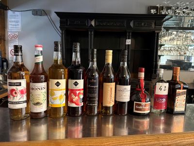 many bottles of alcohol lined up on the bar