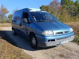 a blue van that is parked on the side of the road