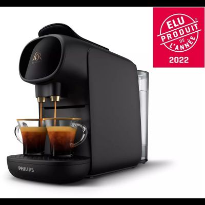 a close up of a coffee machine with two cups of coffee
