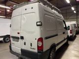 a white van parked in a garage with other vans