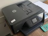 a printer sitting on top of a desk next to a calculator