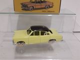 a yellow toy car on display in a clear case