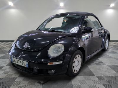 a picture of a black volkswagen beetle parked on a checkered floor