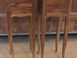 two wooden tables that are sitting next to each other