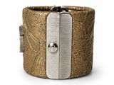 the cuff bracelet is made of leather and has a metal clasp