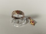 a gold ring with a pink stone in it and a gold ring with a pink stone in it