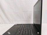 the back of a laptop computer sitting on top of a white table