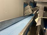 a conveyor belt in a factory with a conveyor belt in the foreground