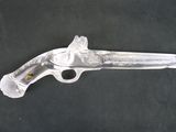 an antique silver plated pistol with a carved handle