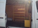 a white van that has a book shelf in the back of it