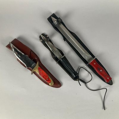 three different types of knives on a white surface