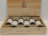 six bottles of wine in a wooden box on a table