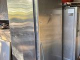 a silver refrigerator in the middle of a kitchen