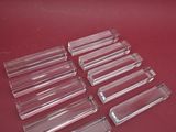 a set of four clear acrylic trays on a red surface