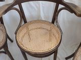 three wooden chairs sitting next to each other on top of a white sheet