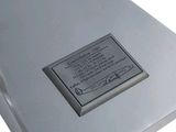 a metal plaque on the side of a white box