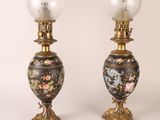 pair of antique lamps with floral designs on them on a white background